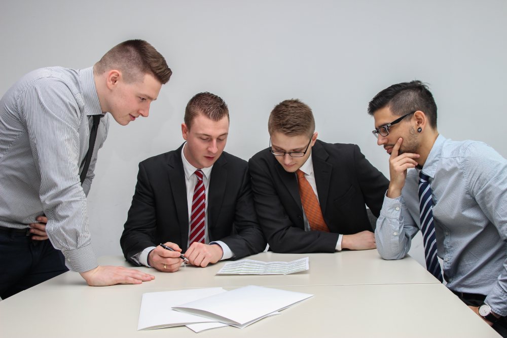 men looking at a document