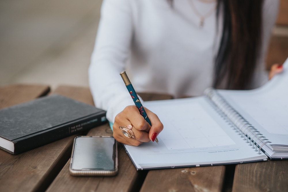 writing on a notebook